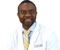 Dr. Adeleke Adesina in a white coat